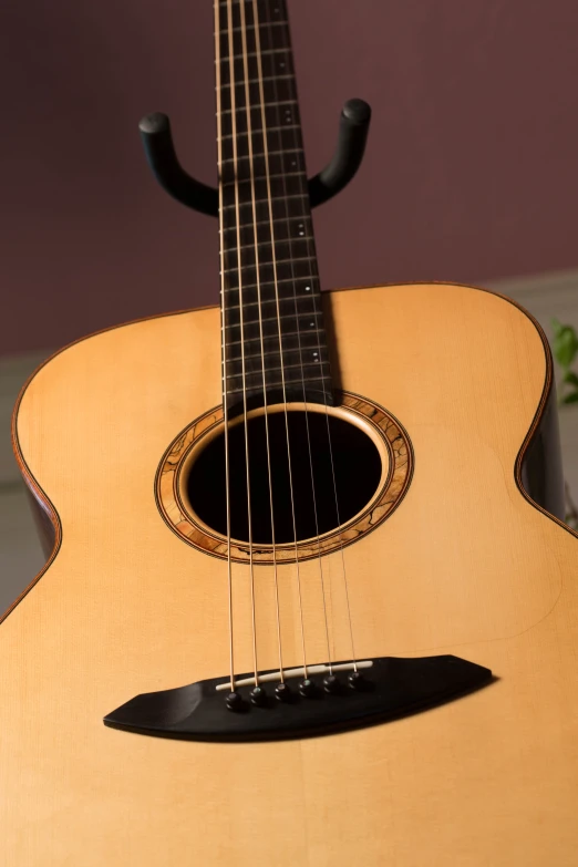 the front and sides of a guitar hanging off a wall