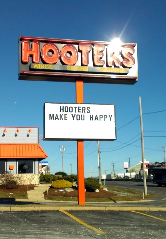 sign that reads hooties make you happy on an orange post