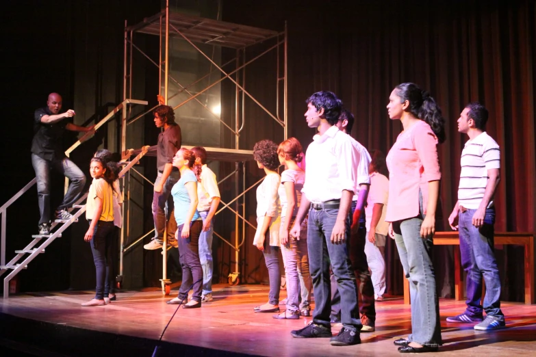 a group of children standing on top of a stage