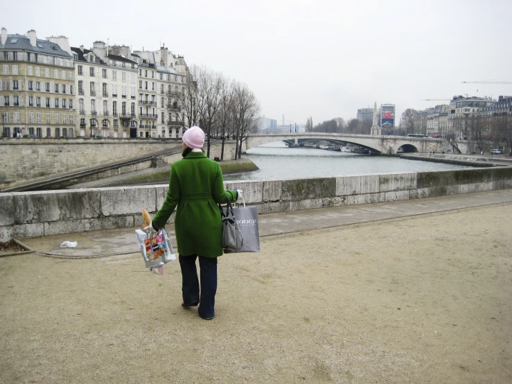 a person is carrying some bags across the walkway