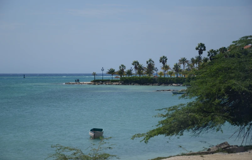 there is a boat on the water near the shore