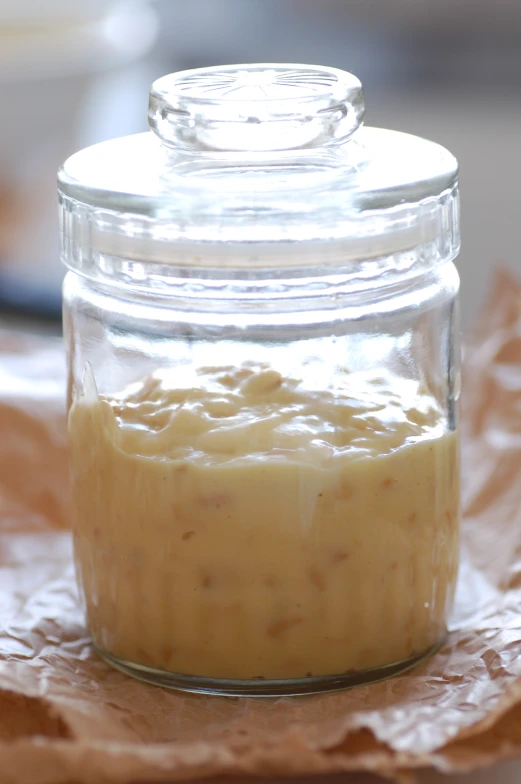 a glass jar full of some kind of sauce