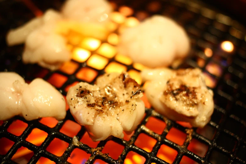 food is cooking on the grill outside