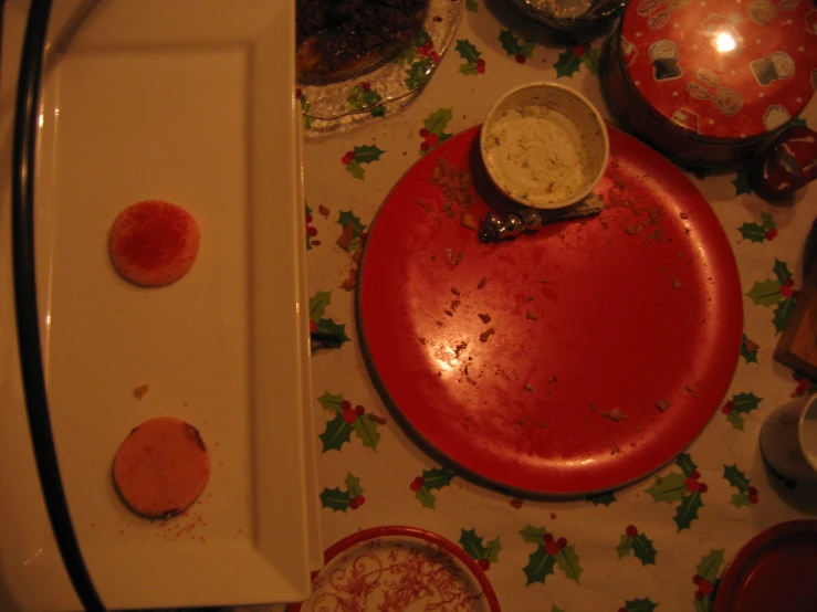 an empty tray sitting on a table next to plates with toppings