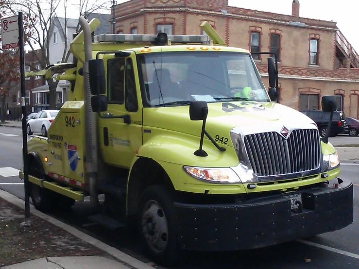 a yellow truck that is sitting on the street