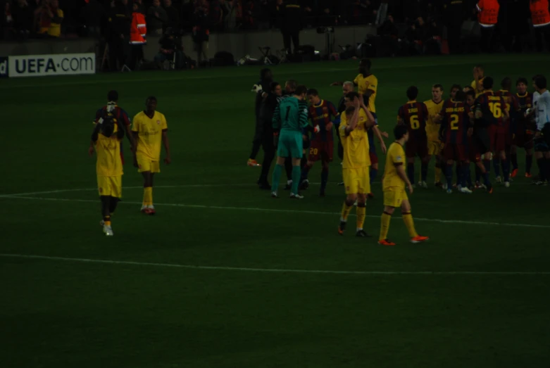 men shaking hands on the soccer field