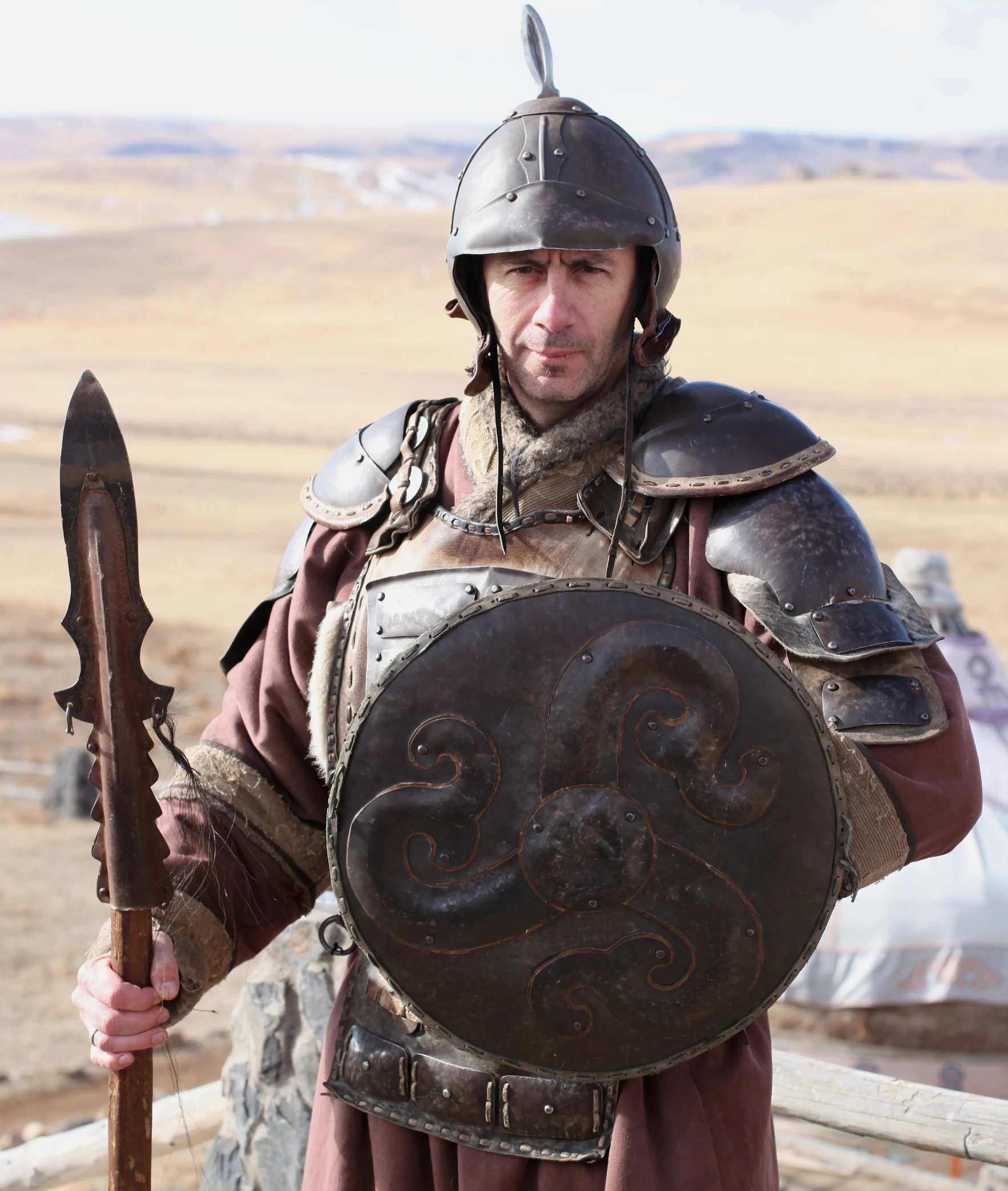 a man with his arm around the shield and sword