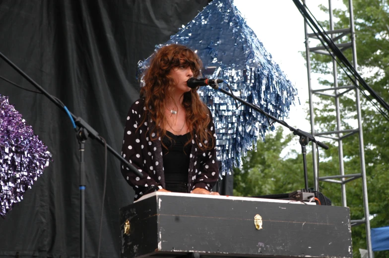 woman standing at podium in front of a microphone