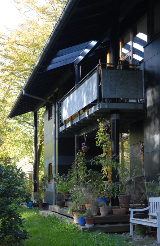 there is a large house that has many plants in the yard