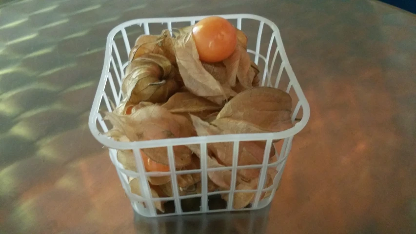 a basket on a table with some food in it