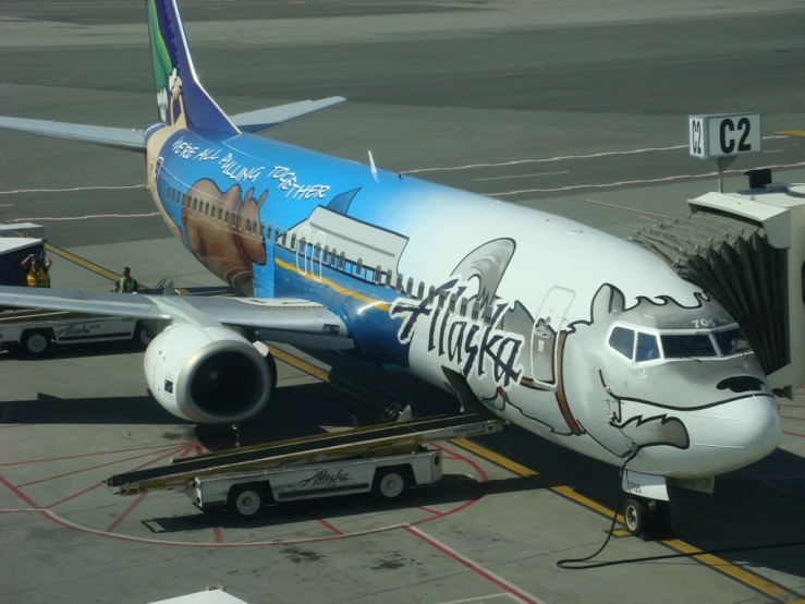 an airplane painted with characters and passengers on its wing