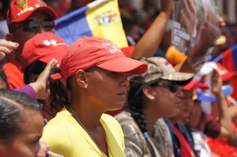 a group of women in red hats standing next to each other