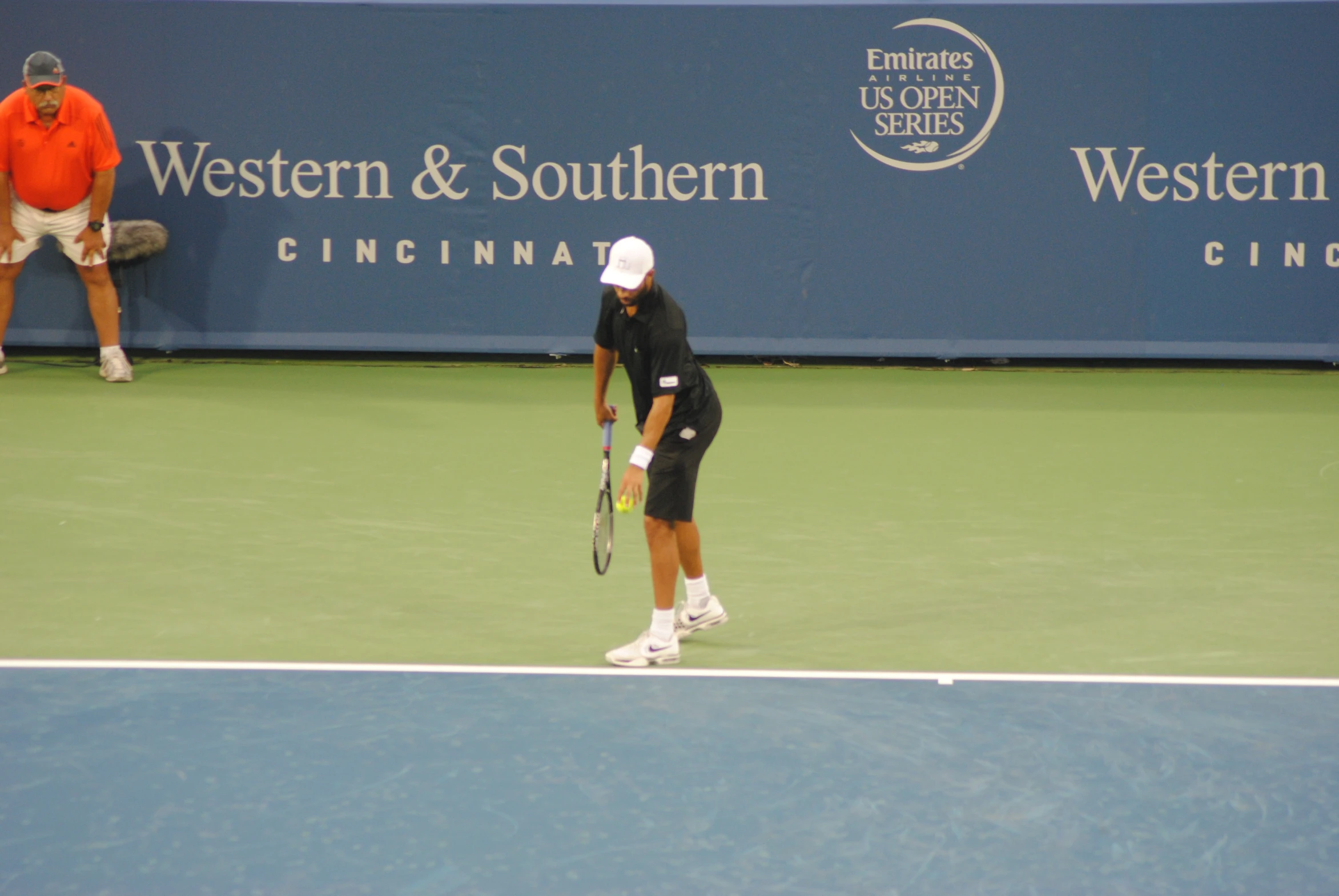 a tennis player preparing to serve the ball