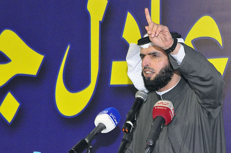 a man in black jacket giving a peace sign