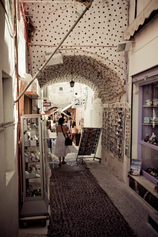 two women walking down a narrow alley way