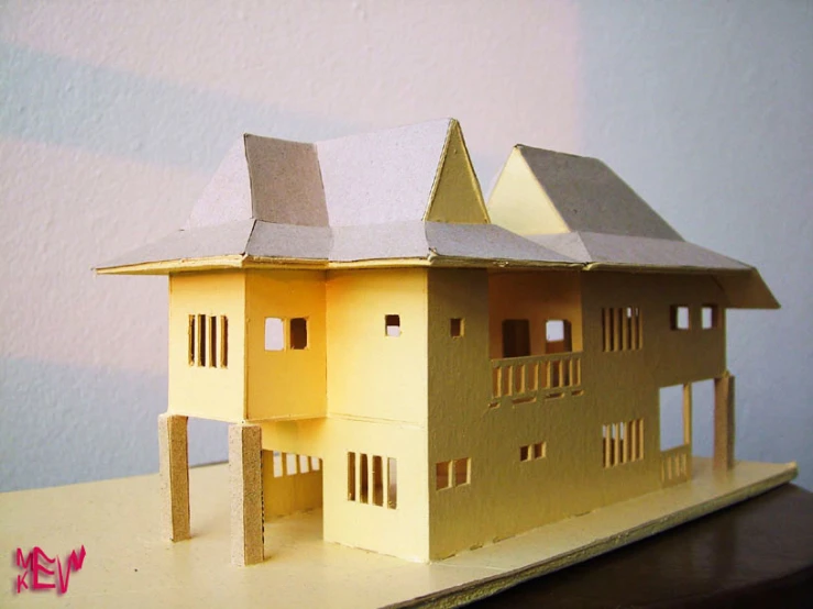 there is a paper model of a home on a table