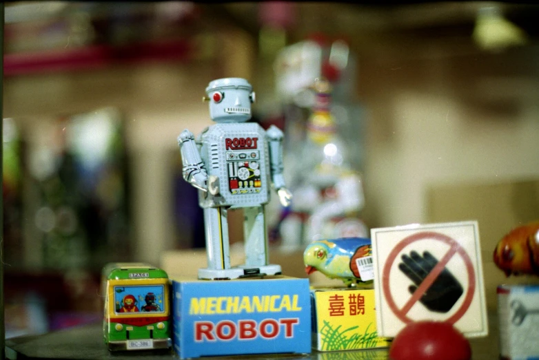 a robot standing next to several small plastic toys