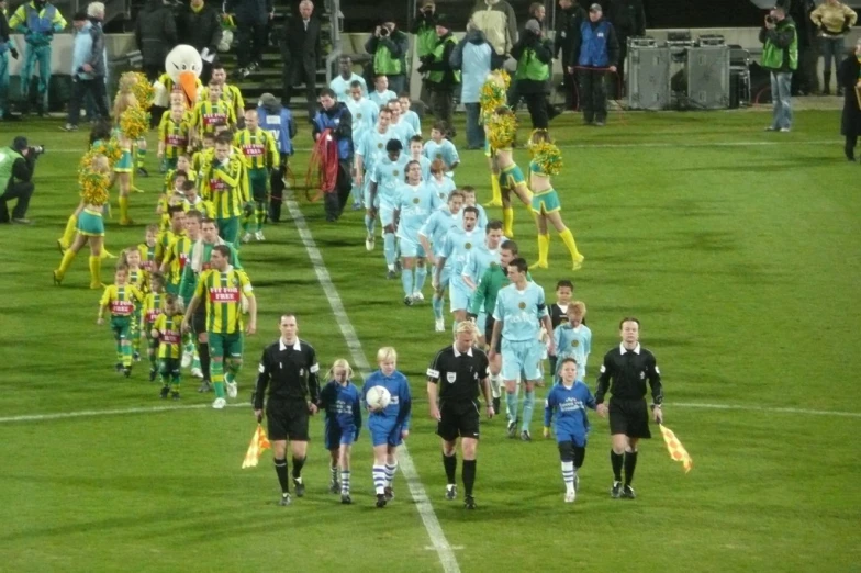 a soccer team that is walking in the field