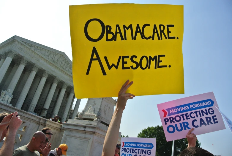 a protest with people holding signs that say obama awesome