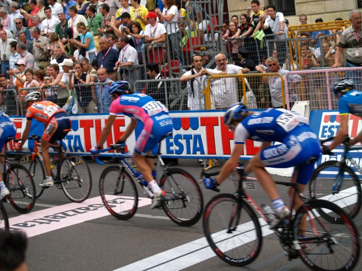 a group of cyclists racing down a road