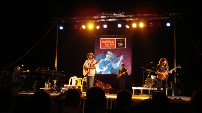 band performing on stage for a crowd at a party