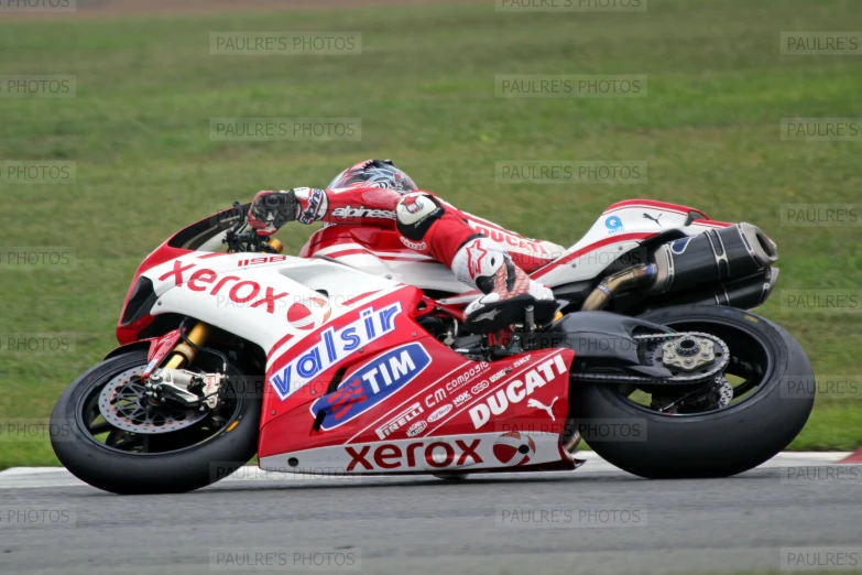 a person riding on the back of a motorcycle on a track