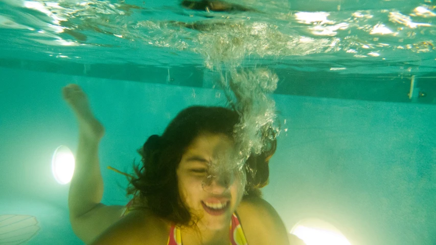 a woman in a bikini floating under water