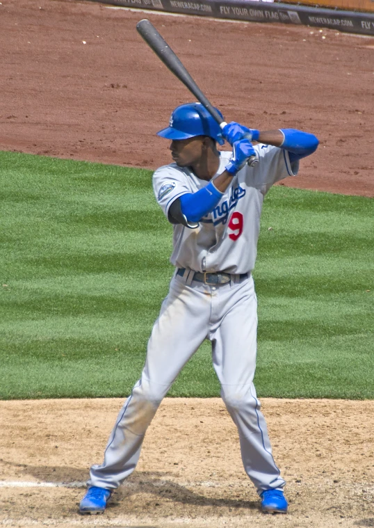 a baseball player standing next to home plate holding a bat