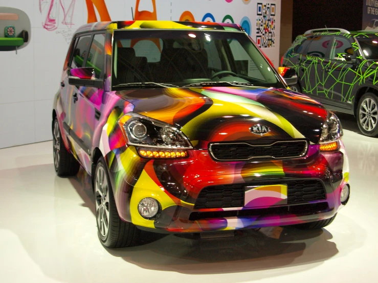 the front end of a brightly colored minivan