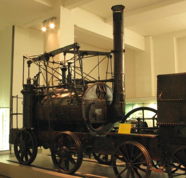 a steam engine sitting on top of a museum floor