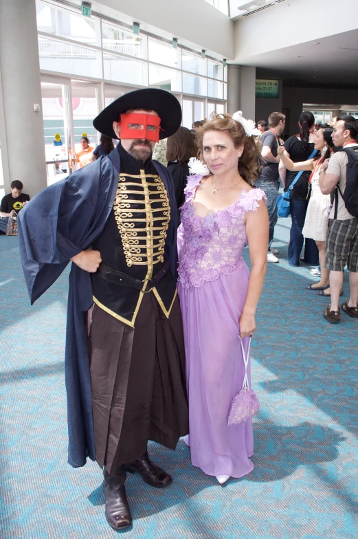 two people dressed in costume and standing together