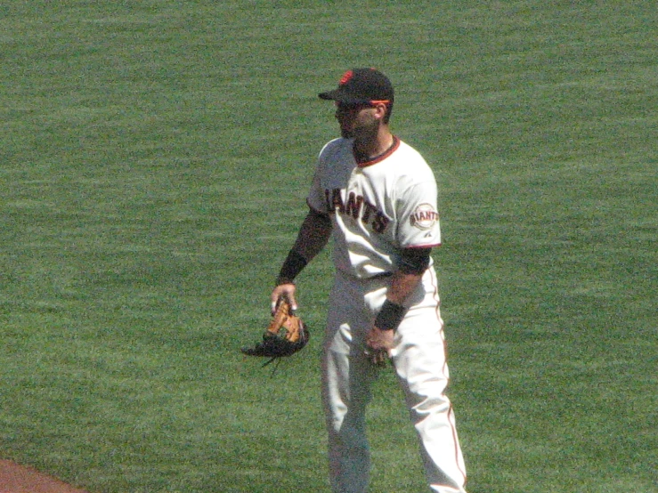 a baseball player on the field with his mitt in hand