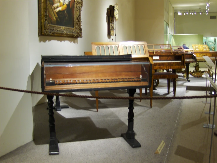 several pieces of art displayed on tables and chairs