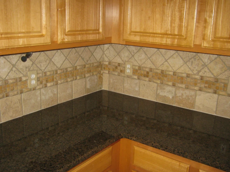 an unfurnished kitchen counter and wall with granite