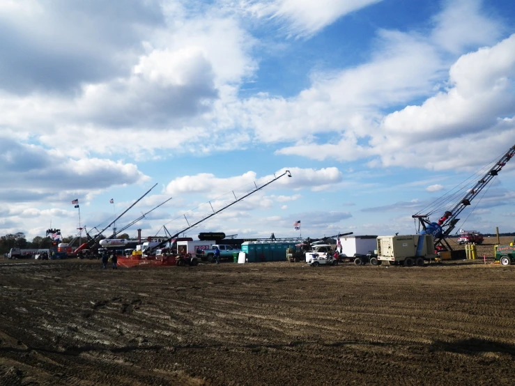 several cranes in a field with an open area