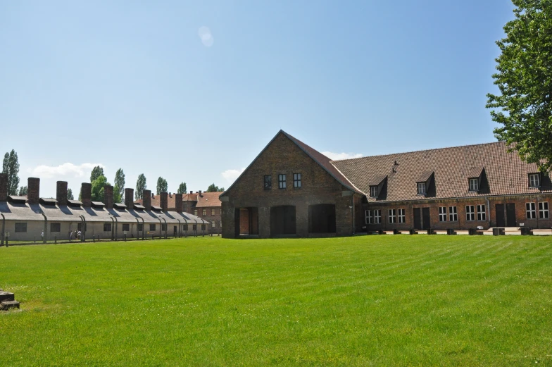 a brick and vinyl house on a green field