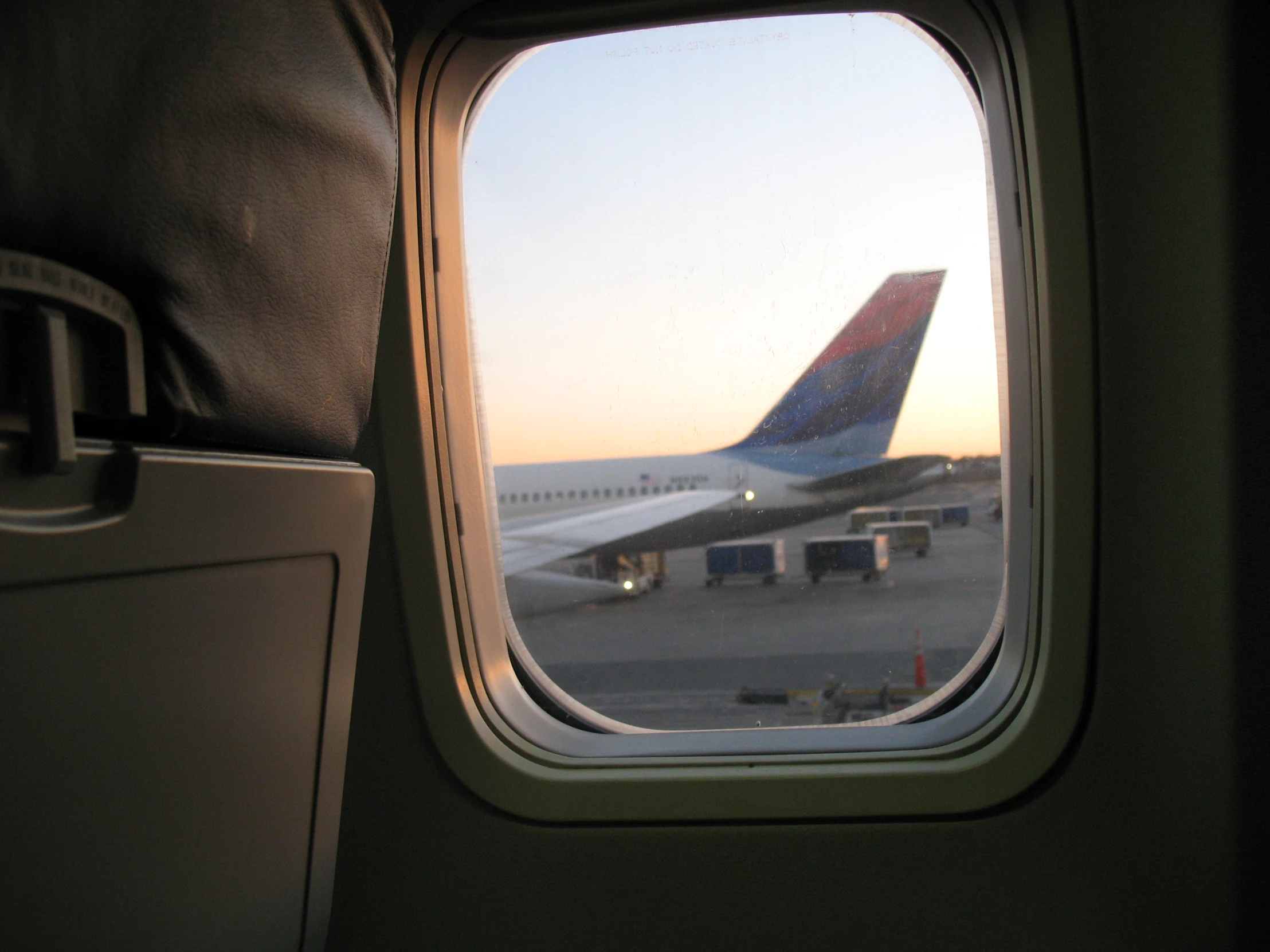 looking out an airplane window at the plane landing