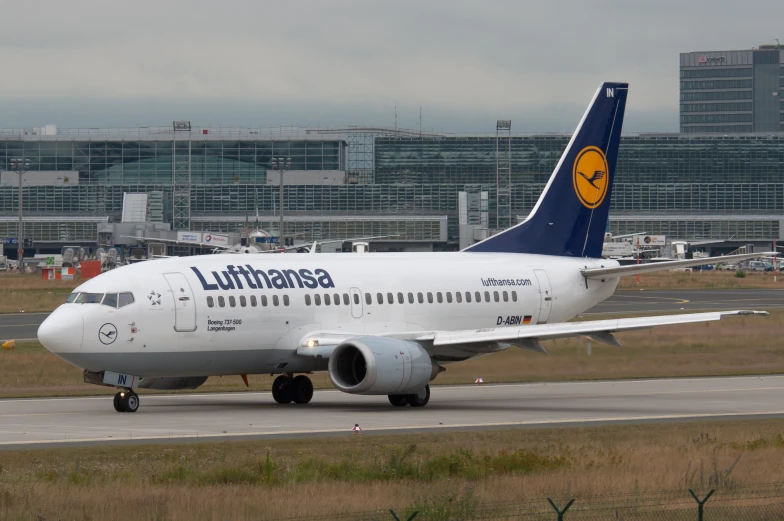 the large white plane is parked on the runway