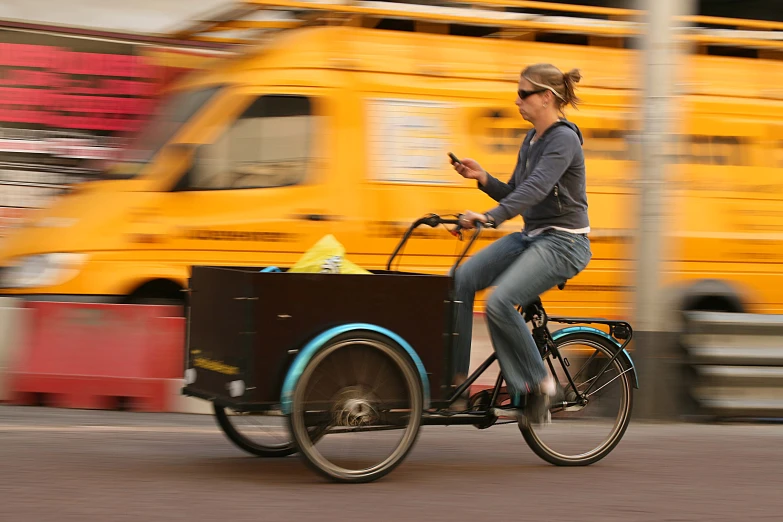 a woman is riding on a bike with a cooler