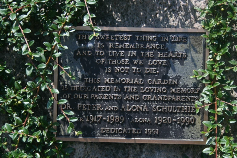 a plaque on the side of a stone wall has words about the church