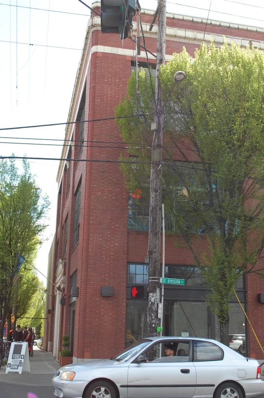 a car parked next to a crosswalk under power lines