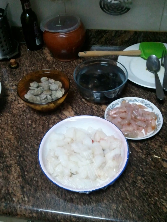 several dishes on the counter in kitchen with bowls of food