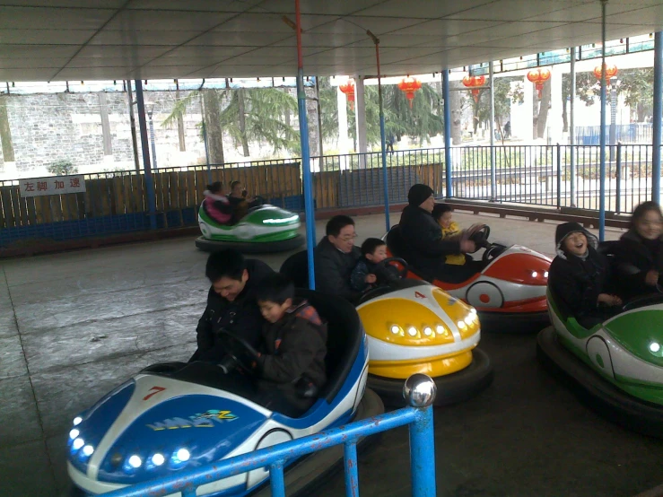 a couple of people are riding on bumper boats