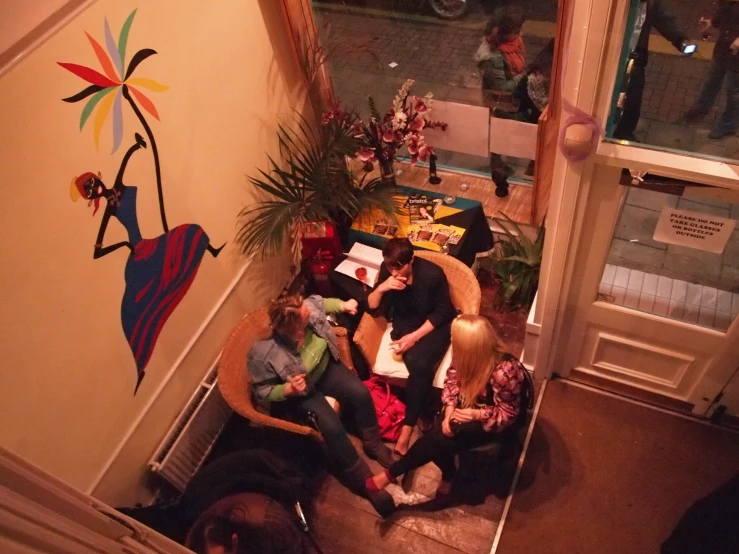 a group of people sitting around a large brown chair