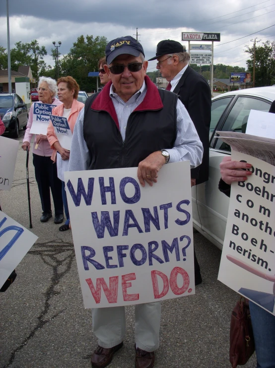 people holding up signs on a street during a protest