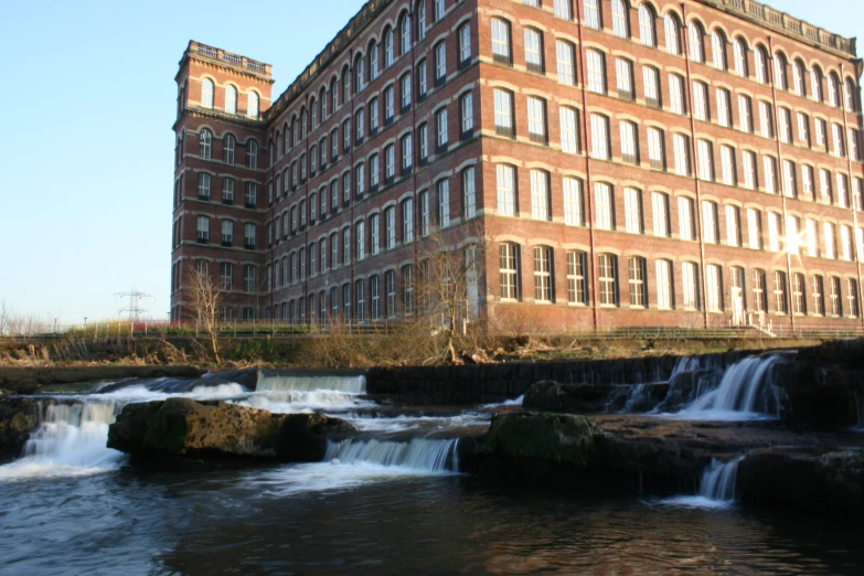 an old building beside the rushing water