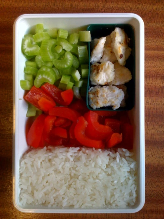 white rice with peppers and cucumbers in a bowl