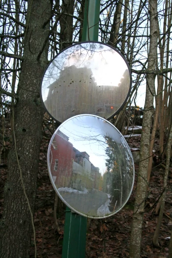 a mirror hanging on the side of a pole