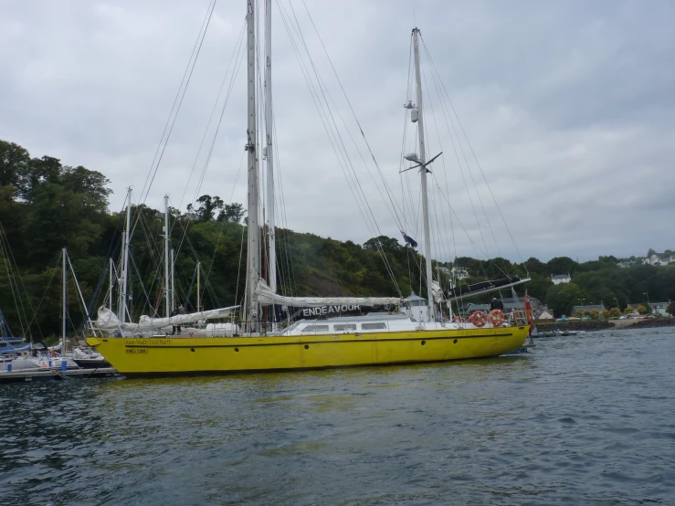 two large yellow boats tied up in the water