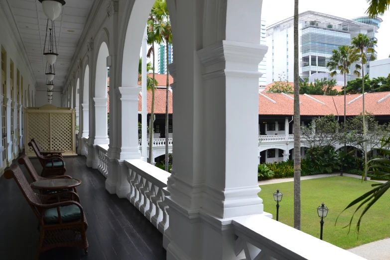 a balcony view of a resort with a lawn in the background